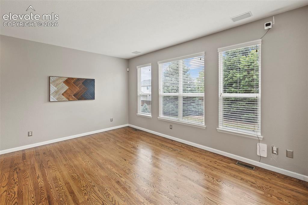 Image 4 of 50: Living room with custom built cabinets, electric fireplace, hardwood floors