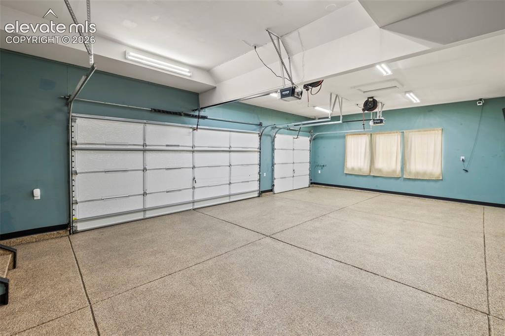 Image 40 of 50: Finished and insulated 3-car garage with epoxied floors