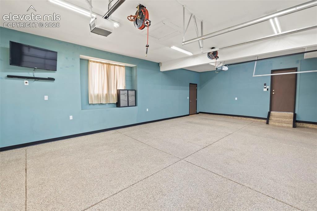 Image 42 of 50: Finished and insulated 3-car garage with epoxied floors