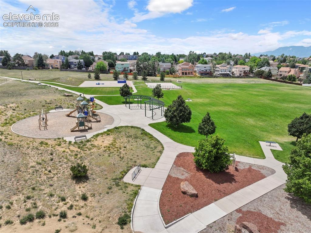Image 48 of 50: Park with walking paths, playground, skate park, and open space