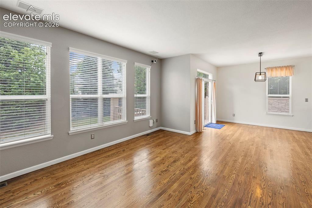 Image 5 of 50: Living room with custom built cabinets, electric fireplace, hardwood floors