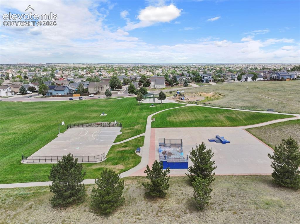 Image 50 of 50: Park with walking paths, playground, skate park, and open space