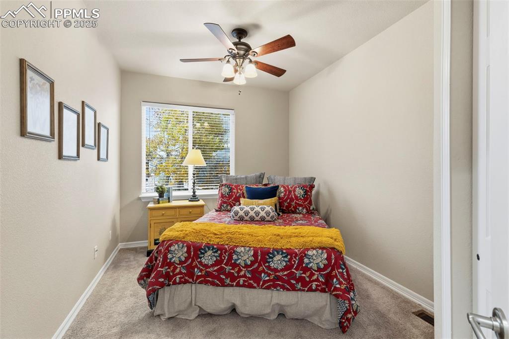 Image 17 of 46: Bedroom with light colored carpet and ceiling fan