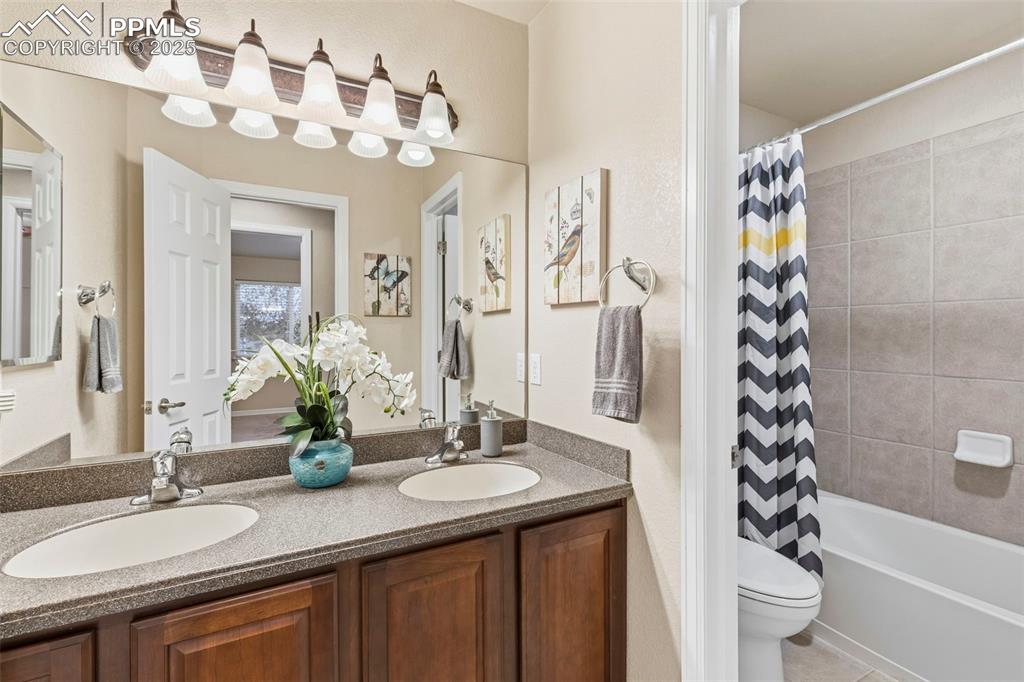 Image 27 of 46: Full bathroom featuring double vanity, shower / bathtub combination with cu