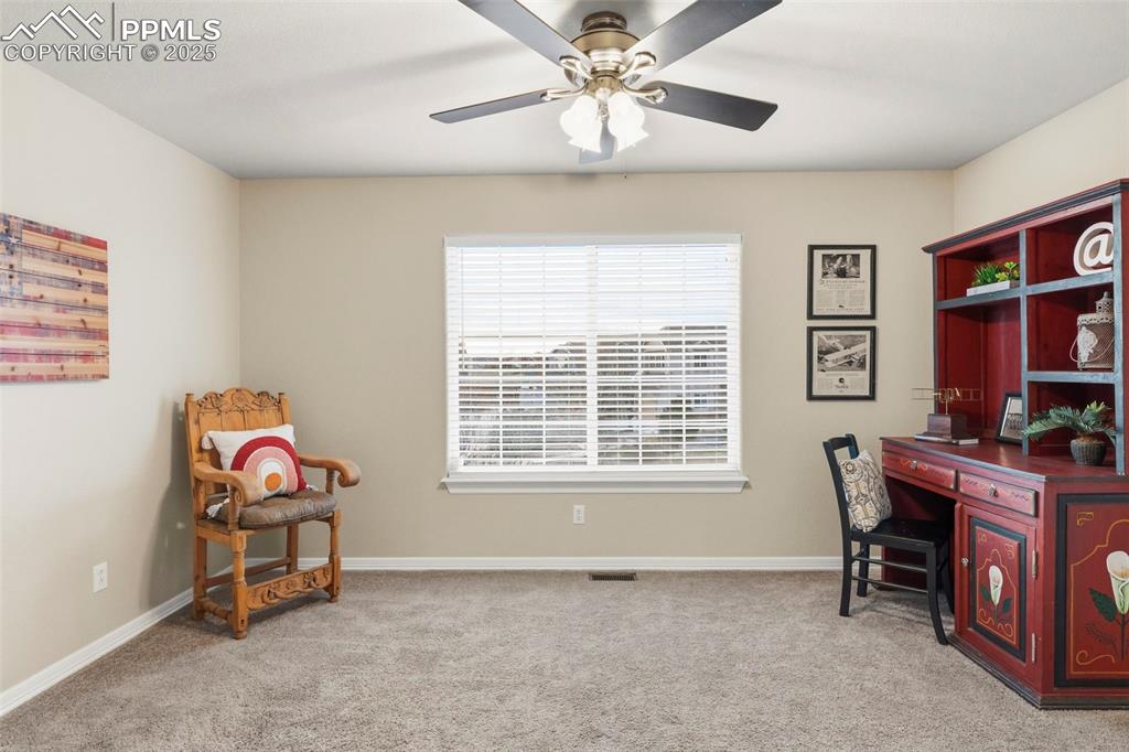 Image 30 of 46: Office space featuring light carpet and a ceiling fan