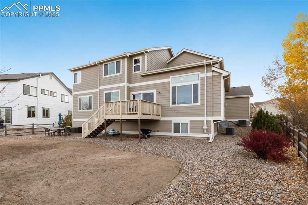 Image 34 of 46: Rear view of house with a deck and stairs