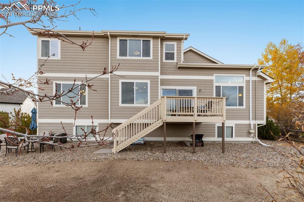 Image 35 of 46: Rear view of house featuring a deck and stairway