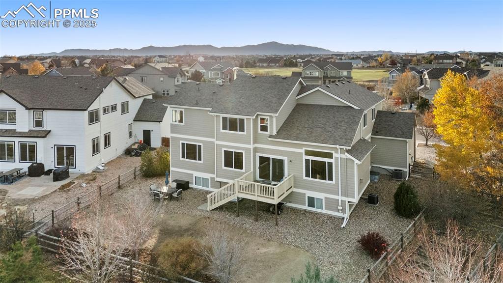 Image 38 of 46: Aerial perspective of suburban area featuring a mountain backdrop