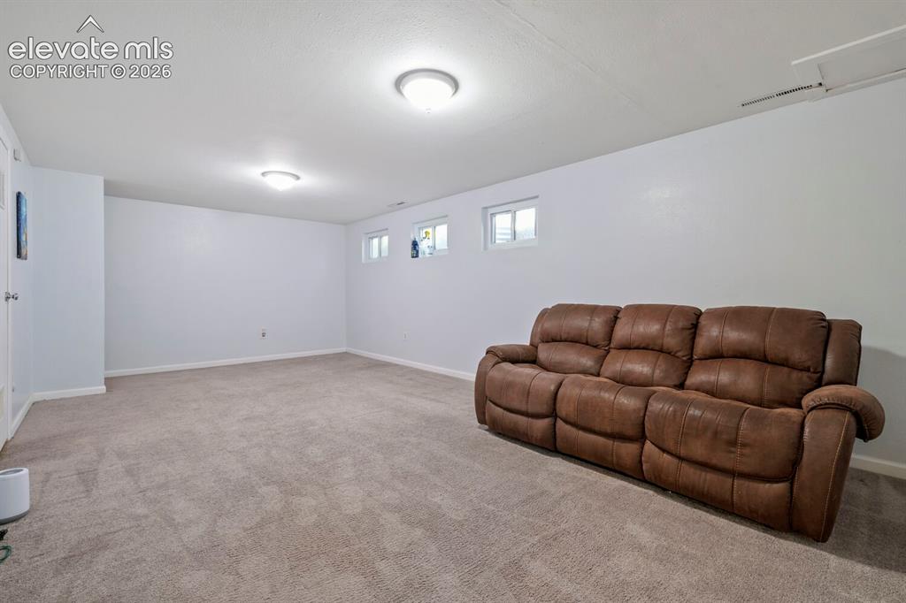 Image 12 of 26: Spacious room featuring neutral carpeting, light-colored walls, and recesse