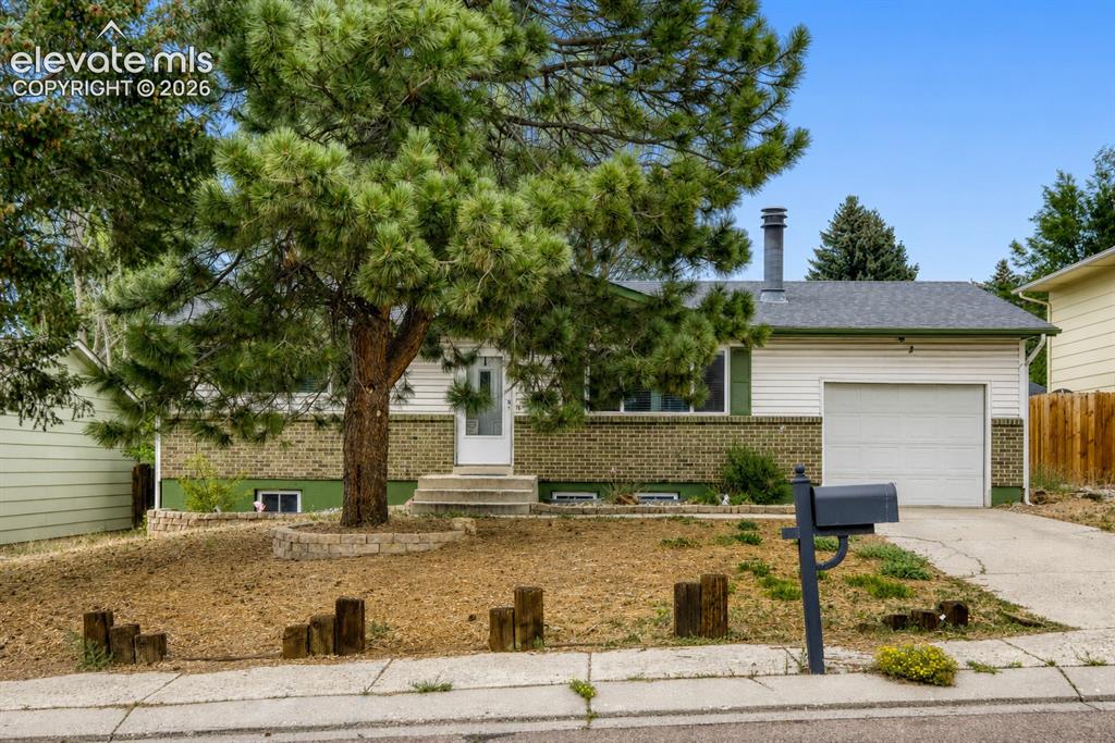 Image 2 of 26: Single-family home featuring a white siding and brick facade, an attached g