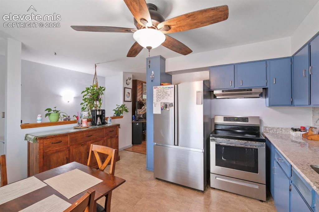Image 7 of 26: Kitchen and dining area featuring a wood-finish dining table and a ceiling