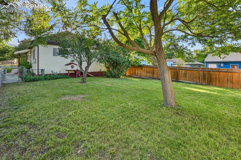 Image 18 of 24: View of fenced backyard