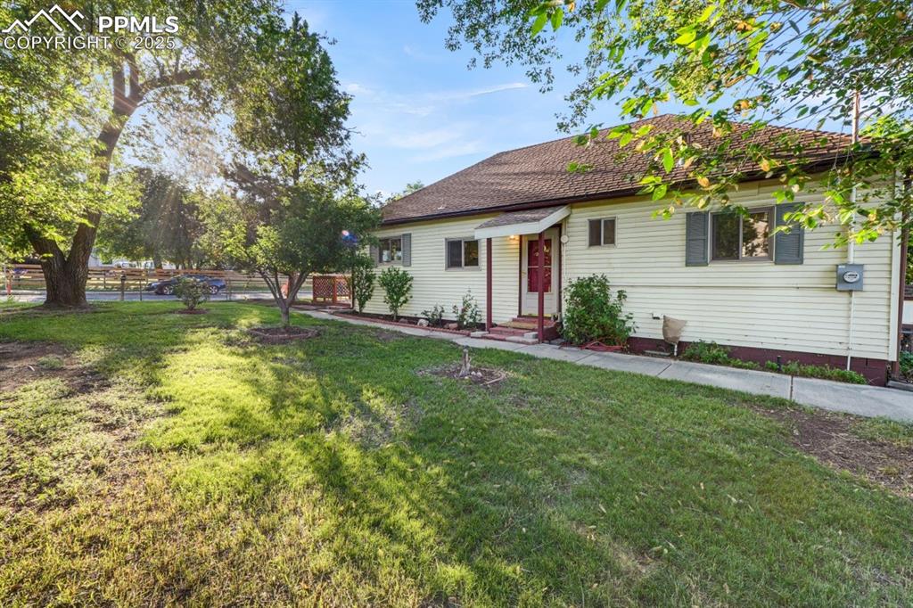 Image 2 of 24: Large front yard with mature landscaping