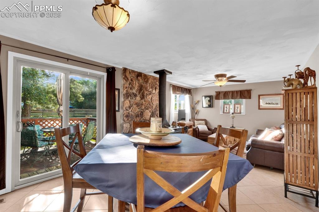 Image 7 of 24: Dining room opens to living room with wood stove for both