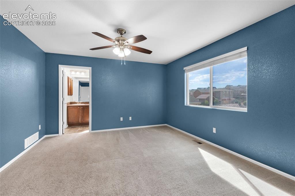 Image 12 of 41: Primary bedroom with abundant natural light and room for a full bedroom sui