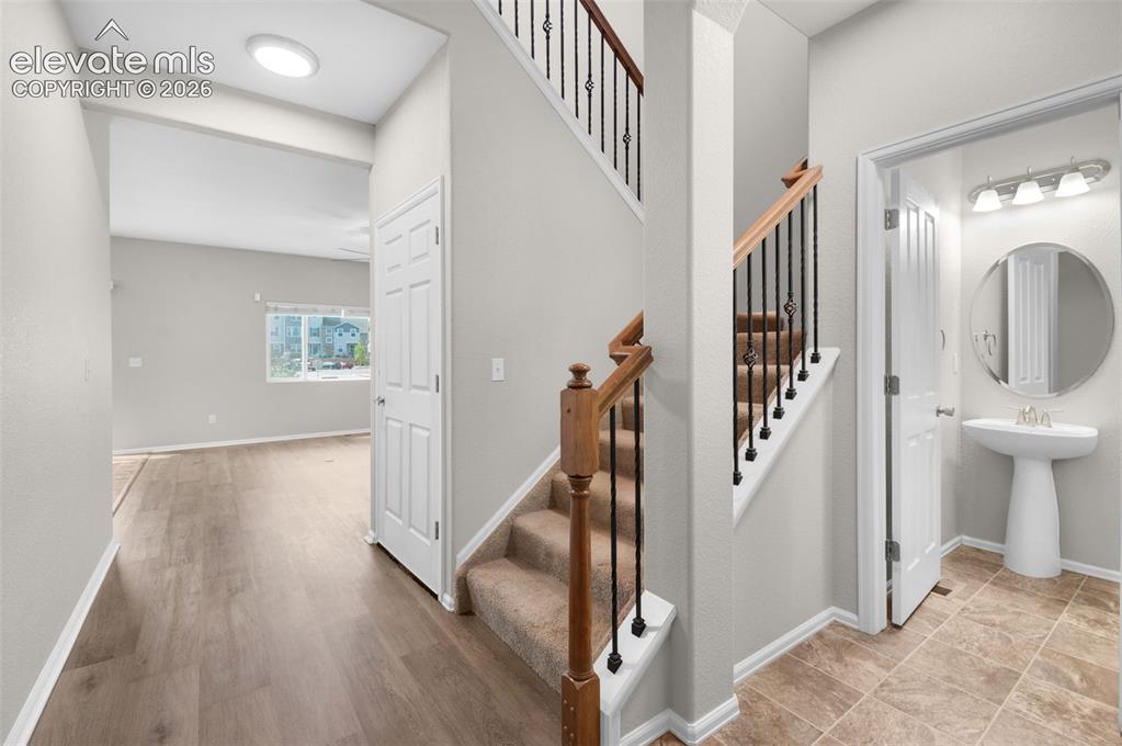 Image 20 of 41: Entry foyer with durable flooring and access to the upper level.