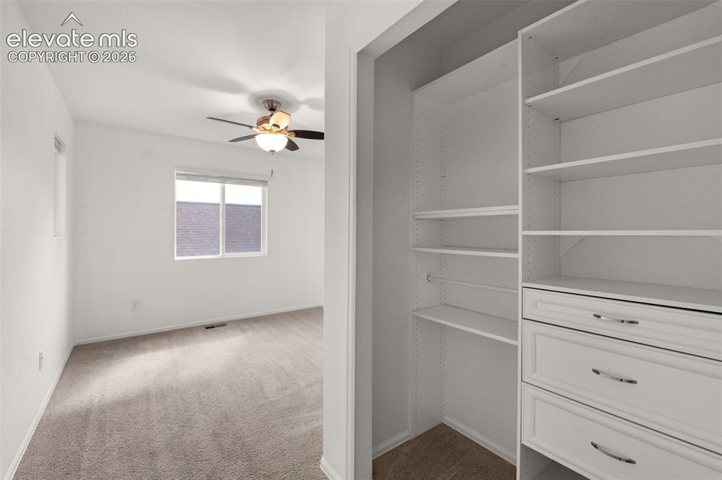 Image 32 of 41: Bedroom closet with built-in shelving for organized storage.
