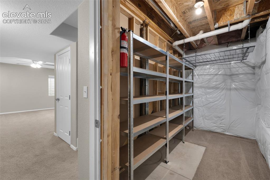 Image 34 of 41: Dedicated basement storage area with extensive built-in shelving.