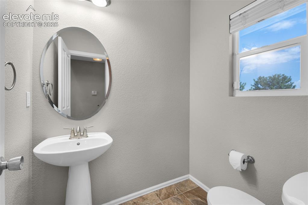 Image 37 of 41: Main-level half bathroom.