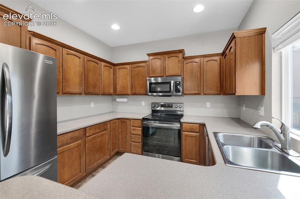 Image 6 of 41: Kitchen with stainless steel appliances, abundant cabinetry and pantry stor