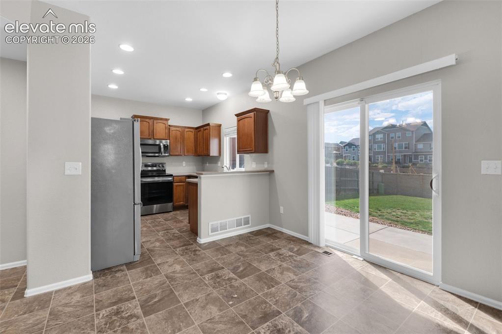 Image 8 of 41: Easy indoor-outdoor connection from the kitchen and dining area to the back
