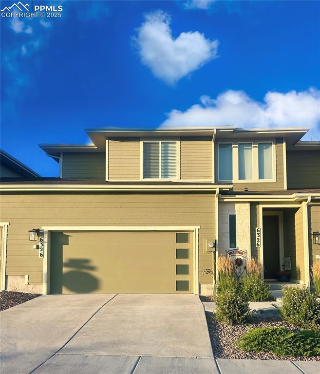 Caption: Lovely west side facing garage and entry. Gets lots of sunshine and the driveway is slightly sloped,