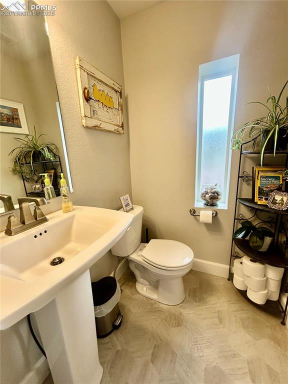 Image 13 of 30: Main level powder room.