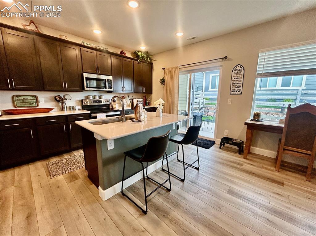 Image 7 of 30: Looking from the living room toward the kitchen. The ample island has a lar