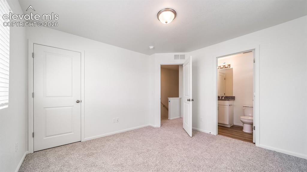 Image 13 of 24: Carpeted flooring throughout, white interior doors, and a flush mount ceili