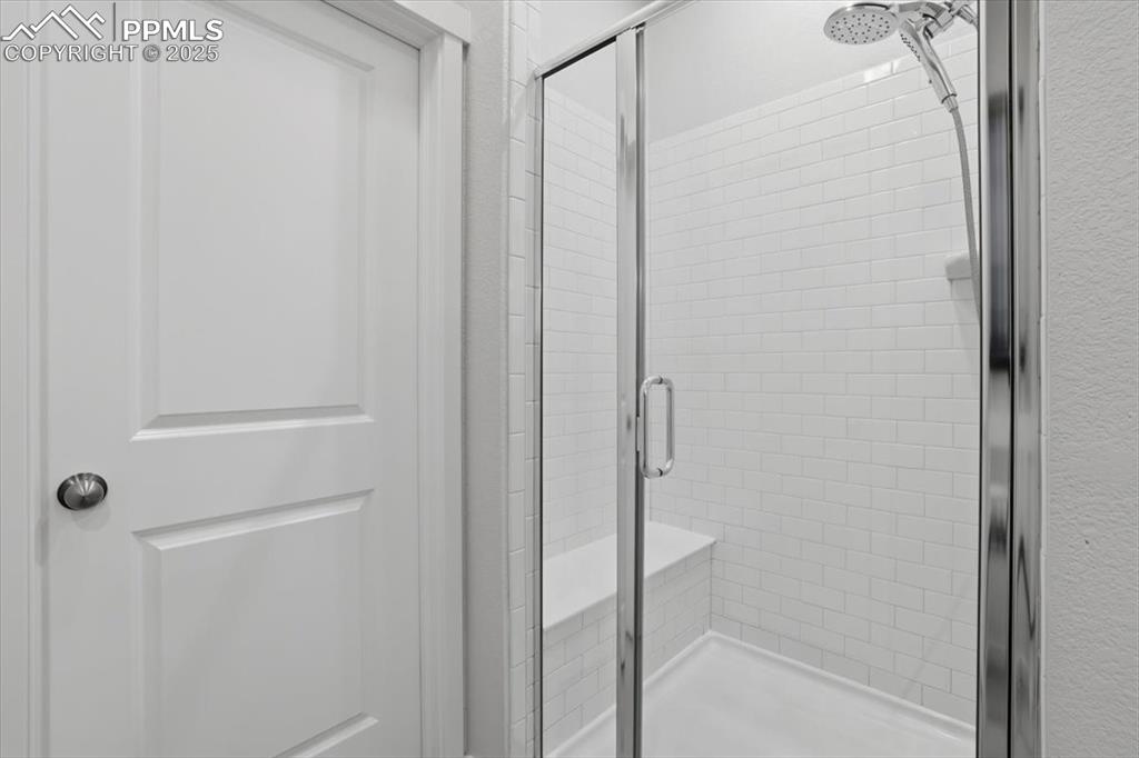 Image 19 of 43: Full bathroom with a stall shower