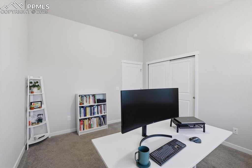 Image 28 of 43: Carpeted office with baseboards