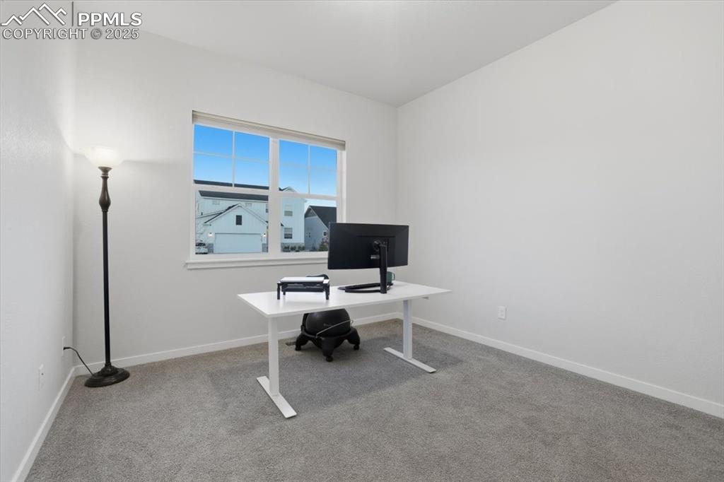 Image 29 of 43: Office featuring light colored carpet and baseboards
