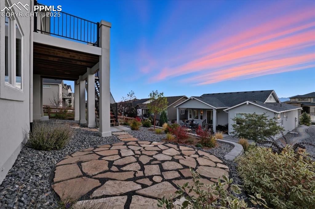 Image 36 of 43: View of patio with a residential view and stairway with access to upper dec
