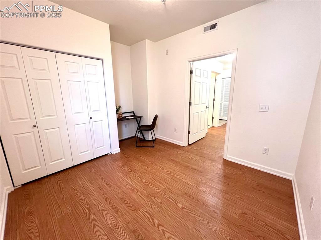 Image 19 of 30: Unfurnished bedroom with hardwood / wood-style flooring and a closet. Spaci