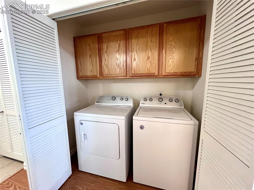 Image 25 of 30: Laundry area featuring hardwood / wood-style flooring, independent washer a