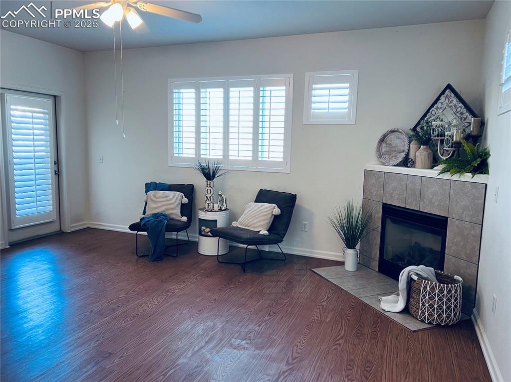 Image 6 of 30: Living area with ceiling fan, a healthy amount of sunlight, wood-type floor