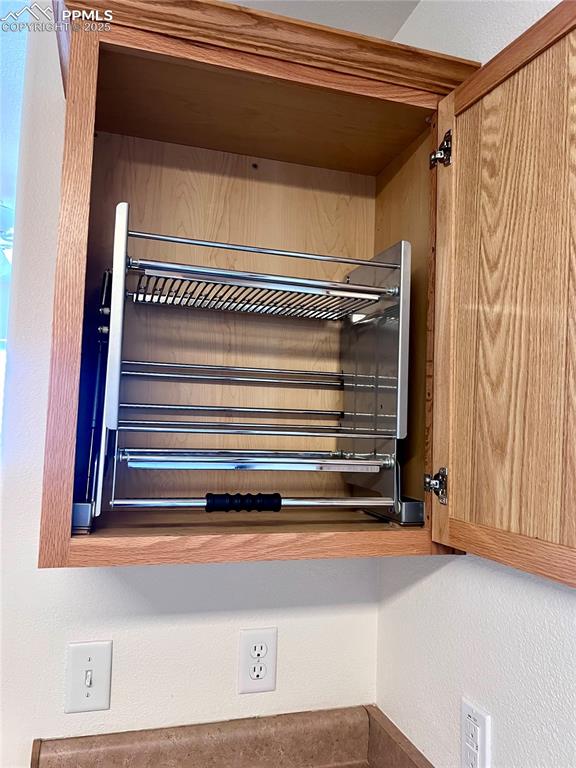 Image 9 of 30: Upper kitchen cabinets feature pull down shelving, ADA compliant and handy 