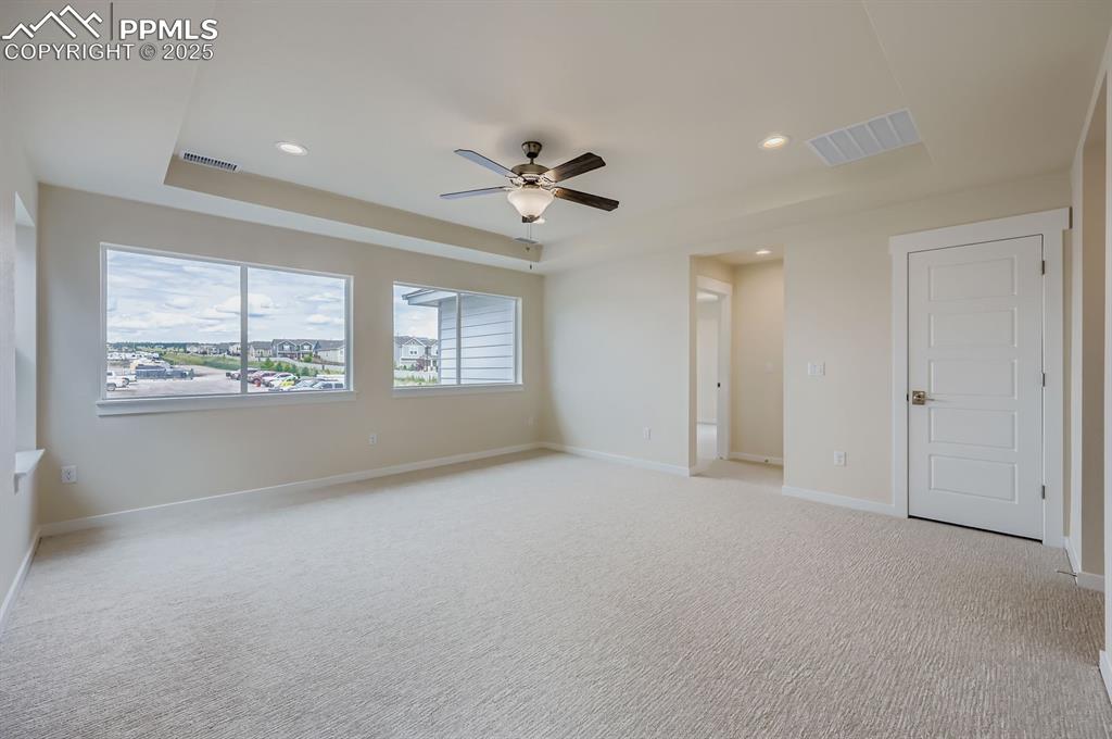Image 23 of 28: Unfurnished room featuring a tray ceiling, recessed lighting, ceiling fan, 