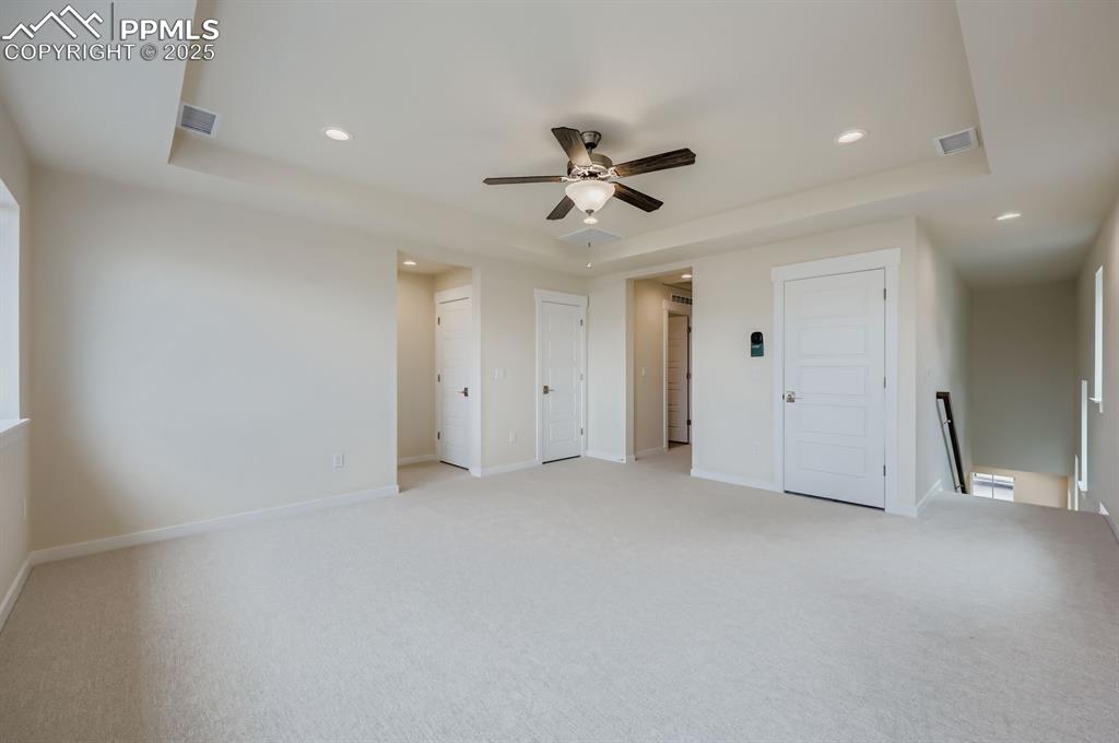 Image 24 of 28: Unfurnished bedroom with recessed lighting, light colored carpet, two close