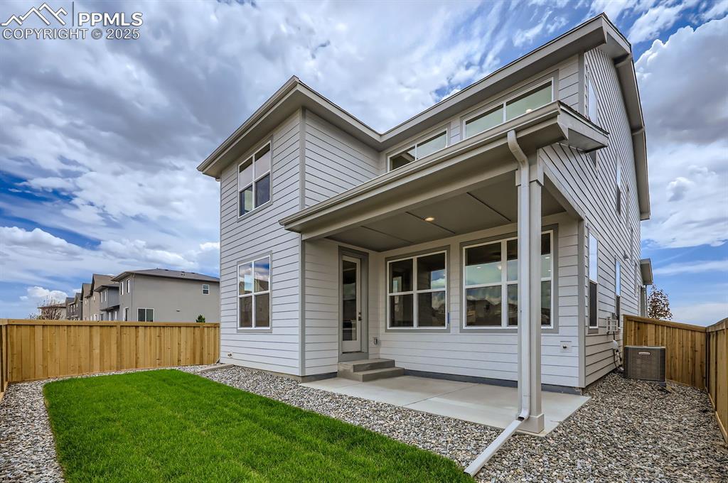 Image 28 of 28: Rear view of house featuring a fenced backyard and a patio area