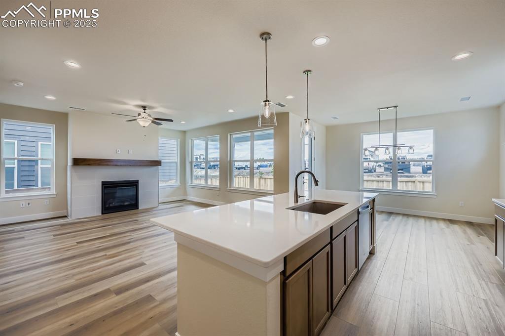Image 8 of 28: Kitchen featuring light wood-style flooring, recessed lighting, an island w