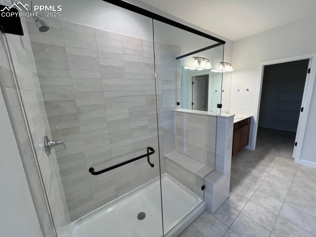 Image 5 of 7: Full bathroom with a stall shower and vanity