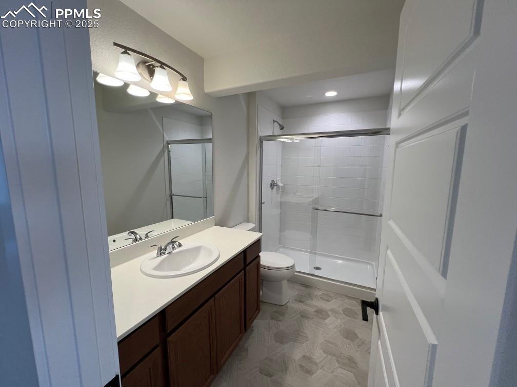 Image 7 of 7: Bathroom featuring vanity, a shower stall, and recessed lighting
