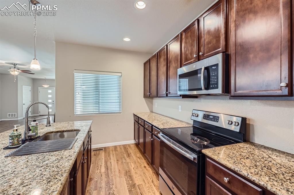 Image 10 of 27: Kitchen featuring stainless steel appliances, light wood finished floors, p