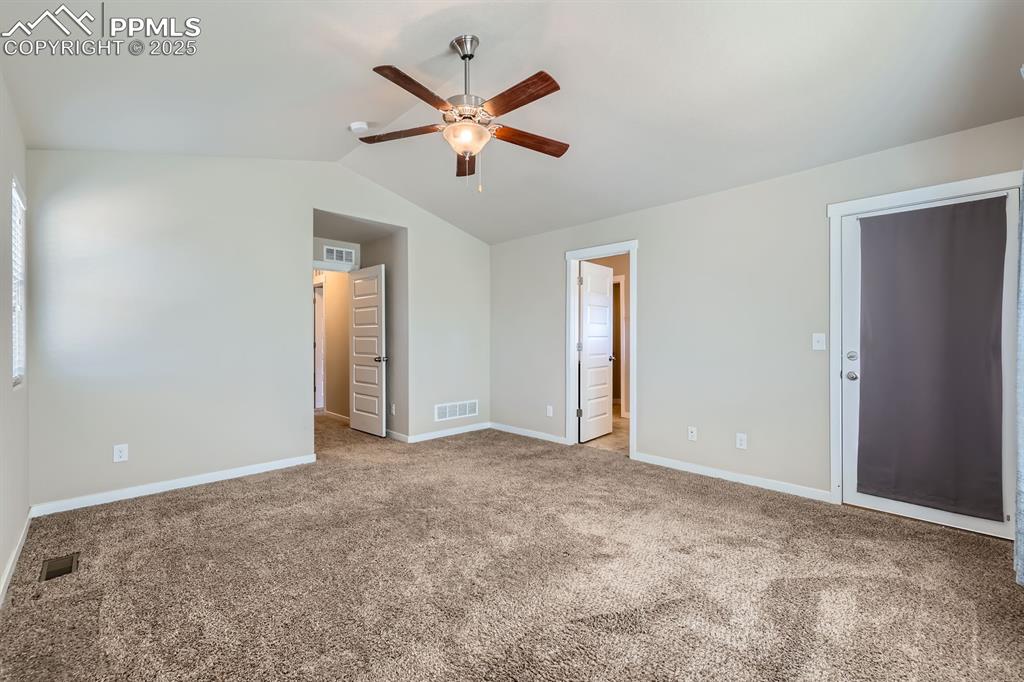 Image 14 of 27: Unfurnished bedroom featuring carpet flooring, vaulted ceiling, a ceiling f