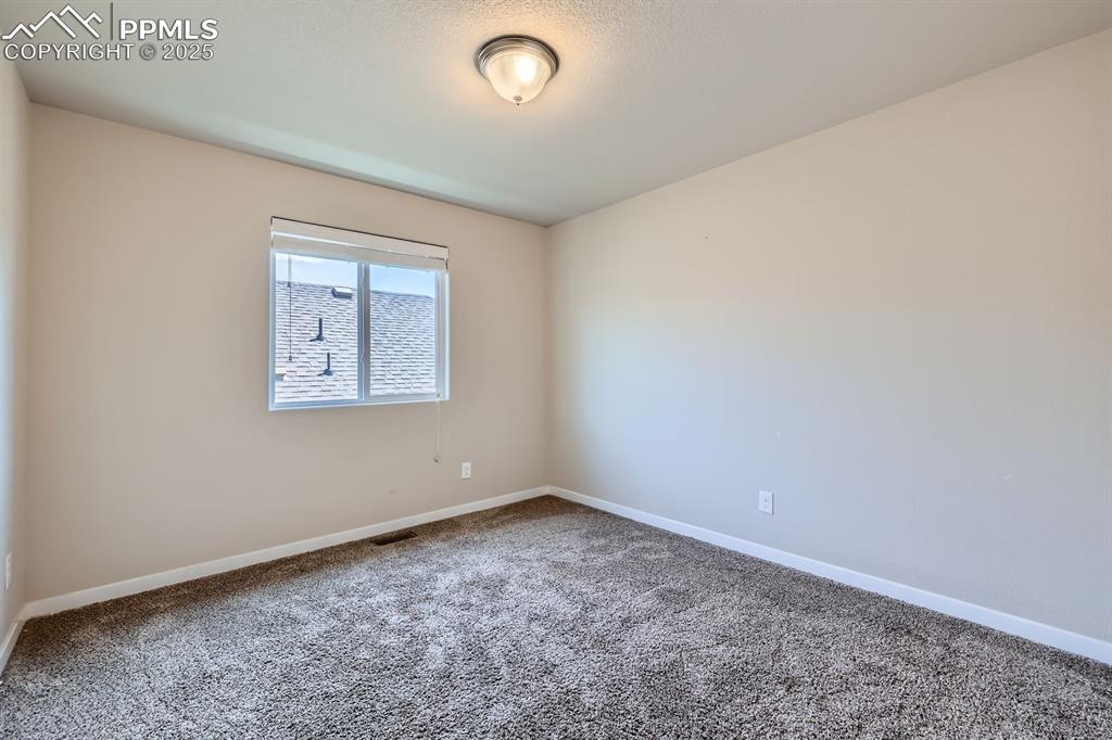 Image 17 of 27: Spare room featuring carpet floors and baseboards