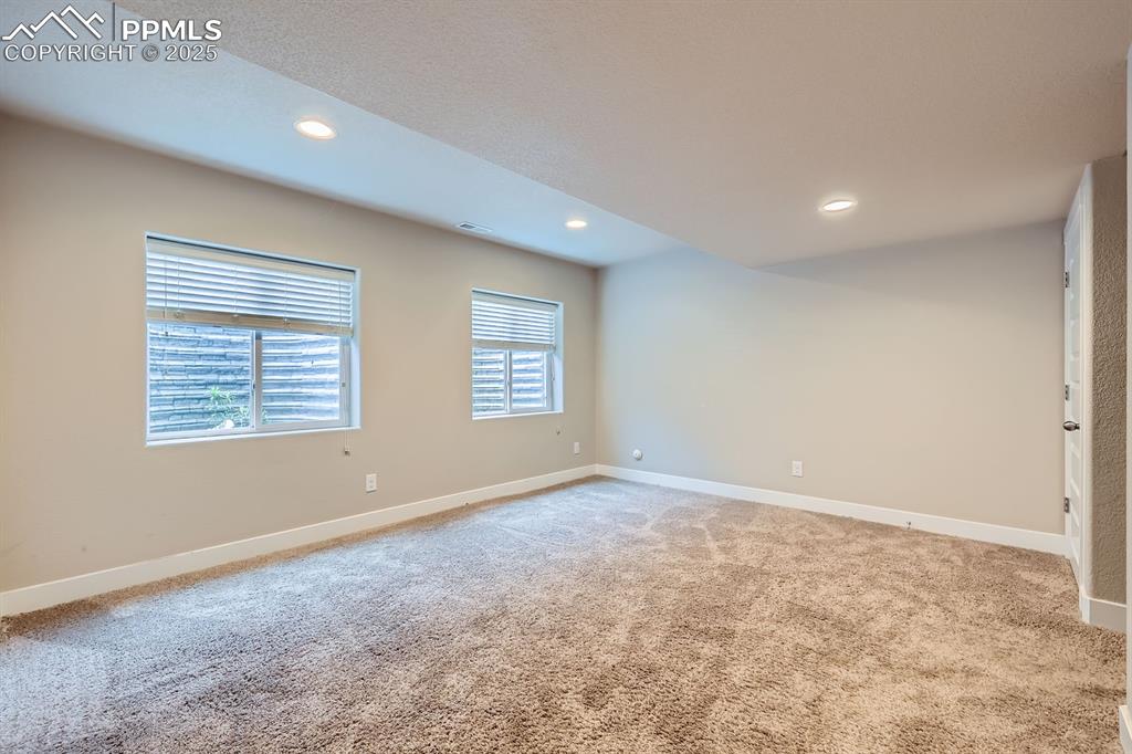 Image 22 of 27: Unfurnished room with light carpet and recessed lighting