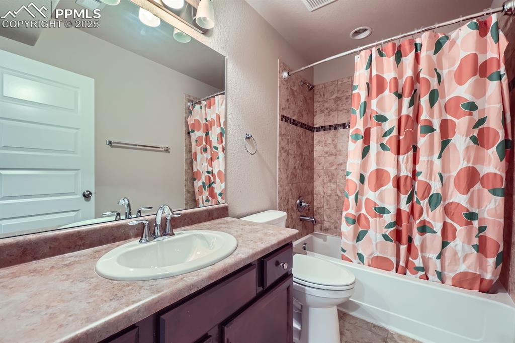 Image 26 of 27: Full bath with vanity, shower / bath combo, and a textured wall