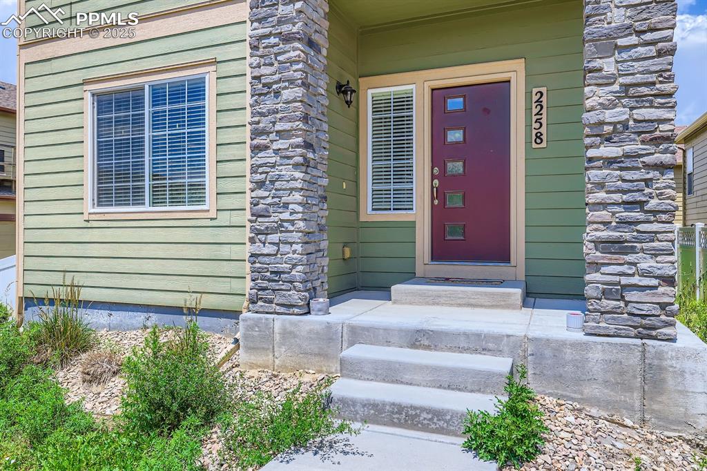 Image 3 of 27: Entrance to property with stone siding