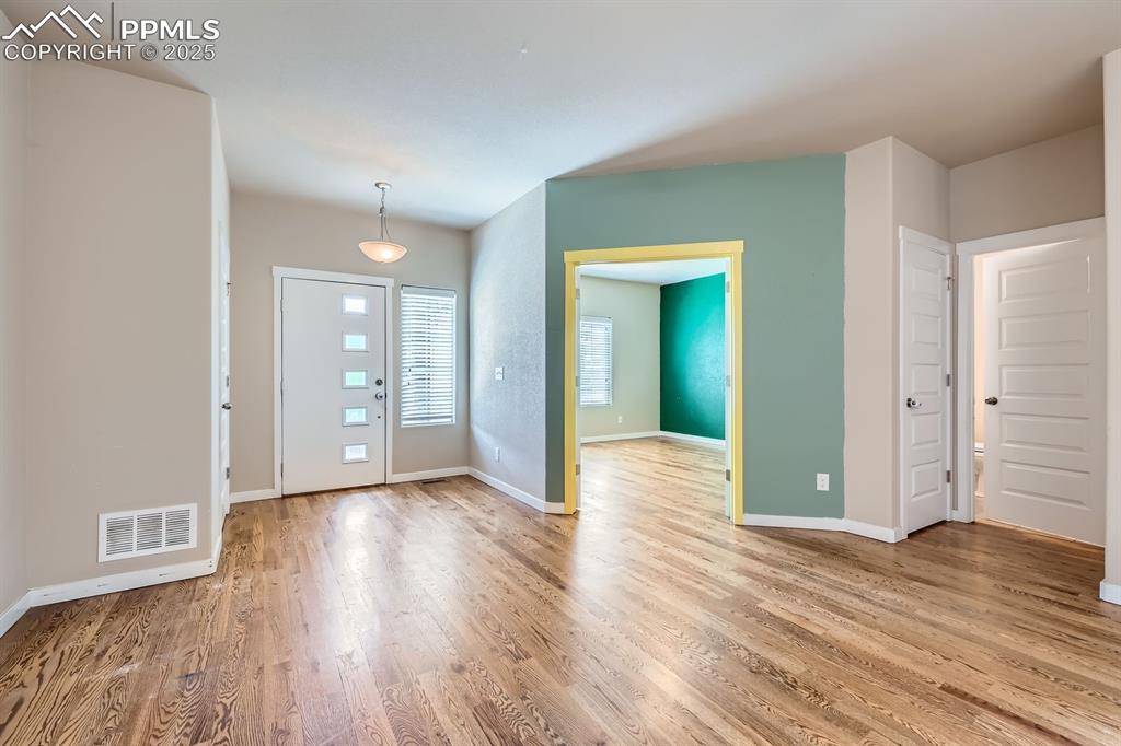 Image 4 of 27: Foyer entrance featuring wood finished floors and baseboards